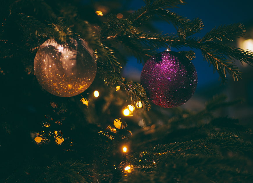 Close-up of Glittering Christmas Ornaments on Pine Branches