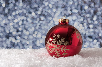 Red Christmas Ornament with Gold Snowflakes on Snow