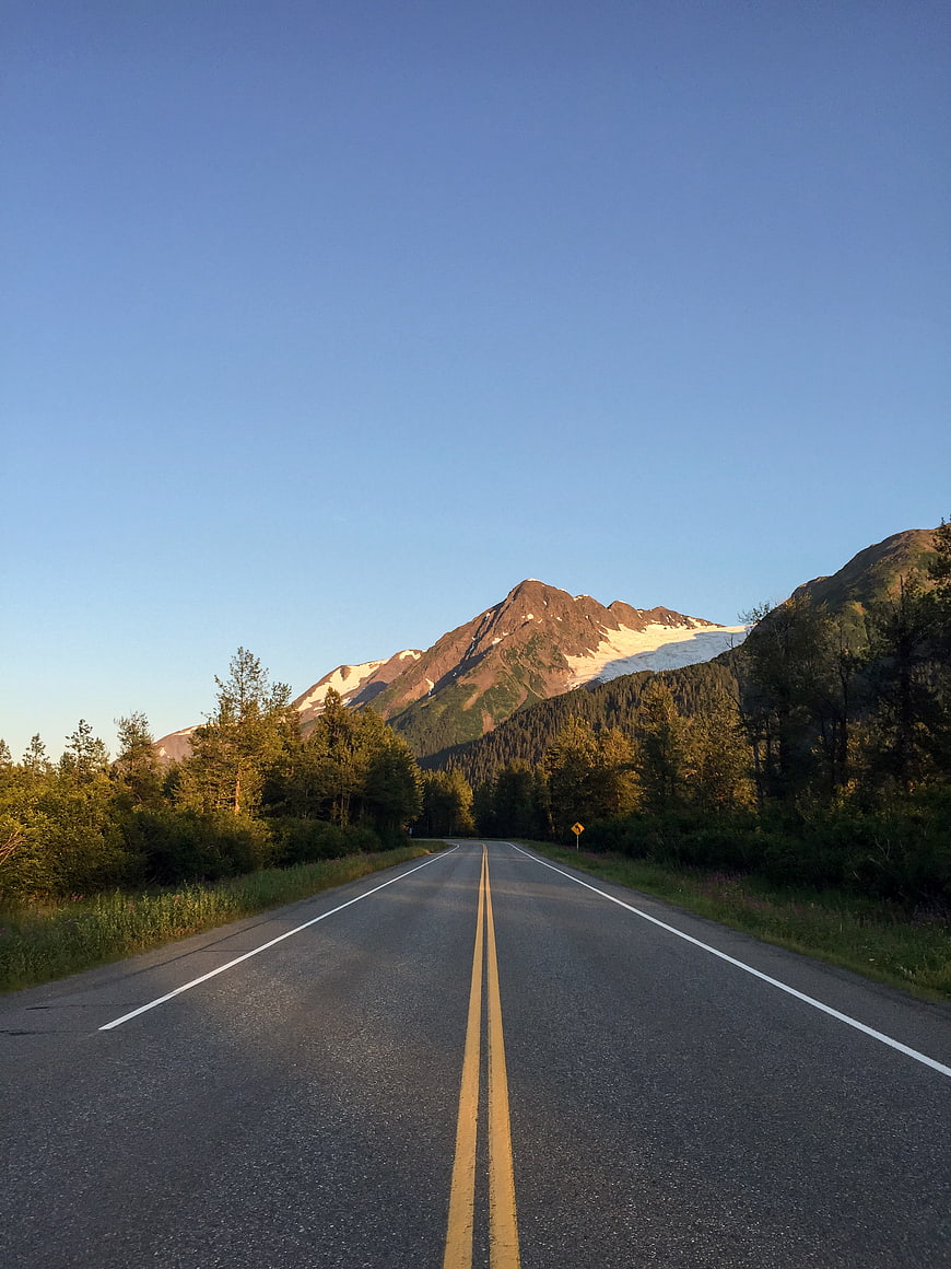 Scenic Highway Leading to Snow-Capped Mountain Peak