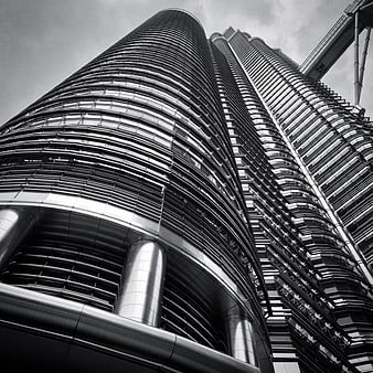 Low angle black and white view of modern skyscraper architecture