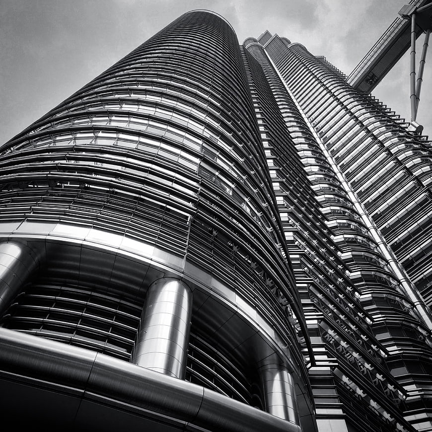 Low angle black and white view of modern skyscraper architecture
