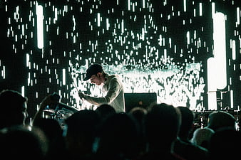 DJ performing live concert with digital rain background