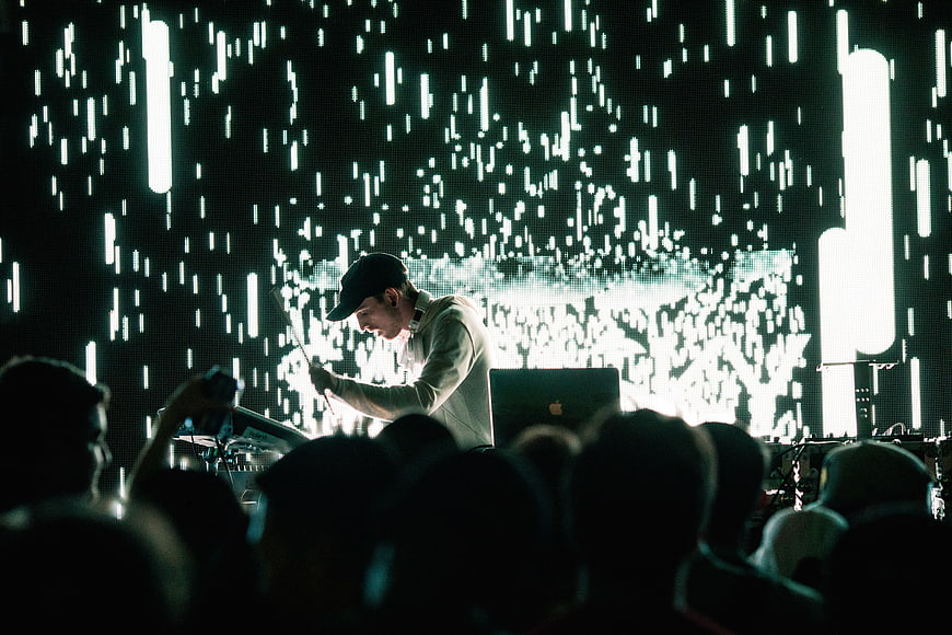 DJ performing live concert with digital rain background
