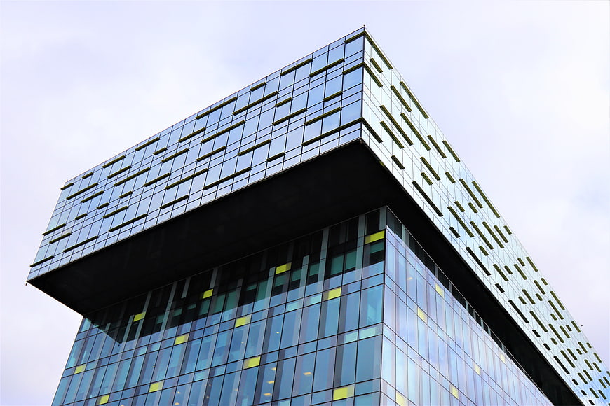 Modern Glass Office Building with Cantilevered Top