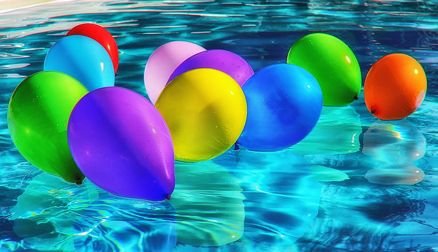 Colorful balloons floating in a swimming pool