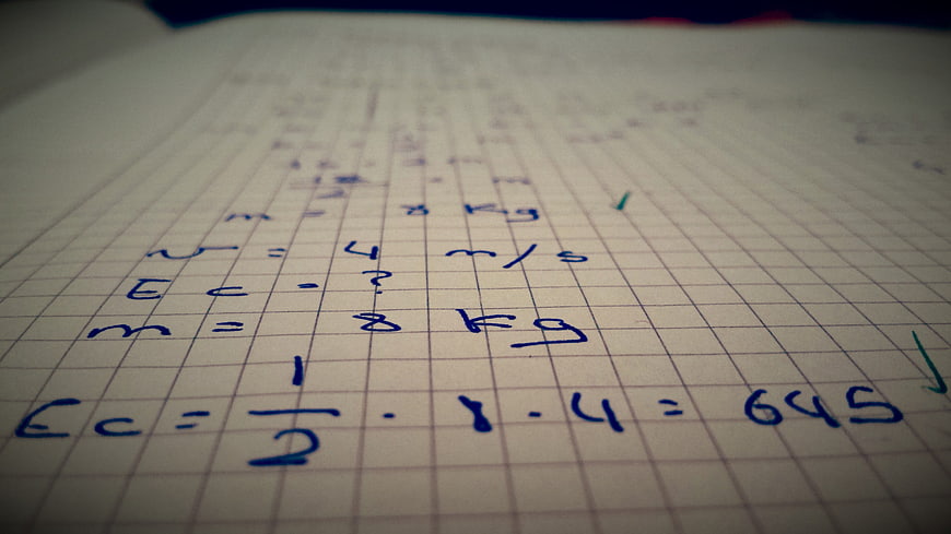Handwritten Physics Equations On Grid Notebook Paper