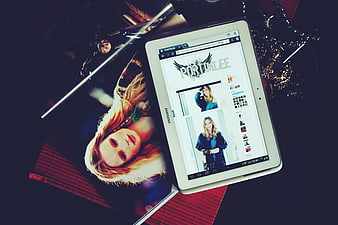 White tablet displaying portfolio website on dark table