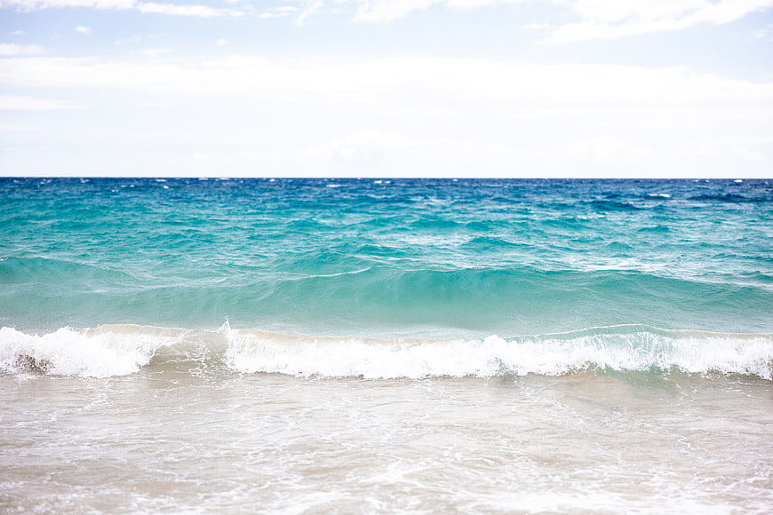 Turquoise Ocean Waves Crashing on Sandy Beach Shore