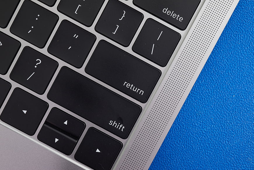 Close-up of laptop keyboard on blue textured background