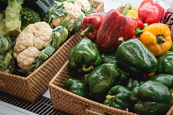 Fresh Bell Peppers and Cauliflower in Wicker Baskets