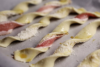 Uncooked Bacon and Cheese Twists on Baking Sheet