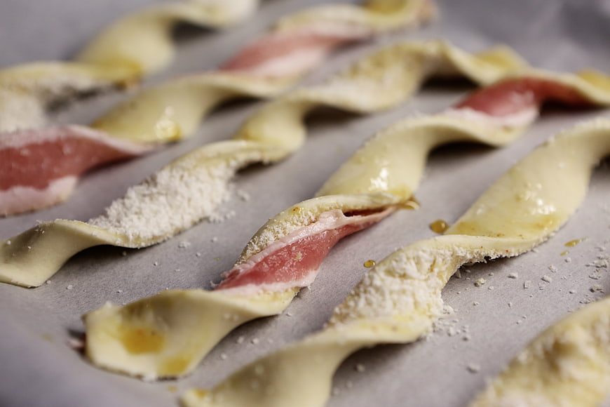 Uncooked Bacon and Cheese Twists on Baking Sheet