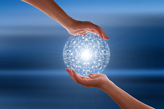 Hands Holding Glowing Digital Network Sphere Against Blue Background