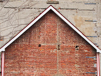 Weathered red brick gable wall with white trim