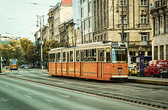 Vintage orange tram on city street in Budapest