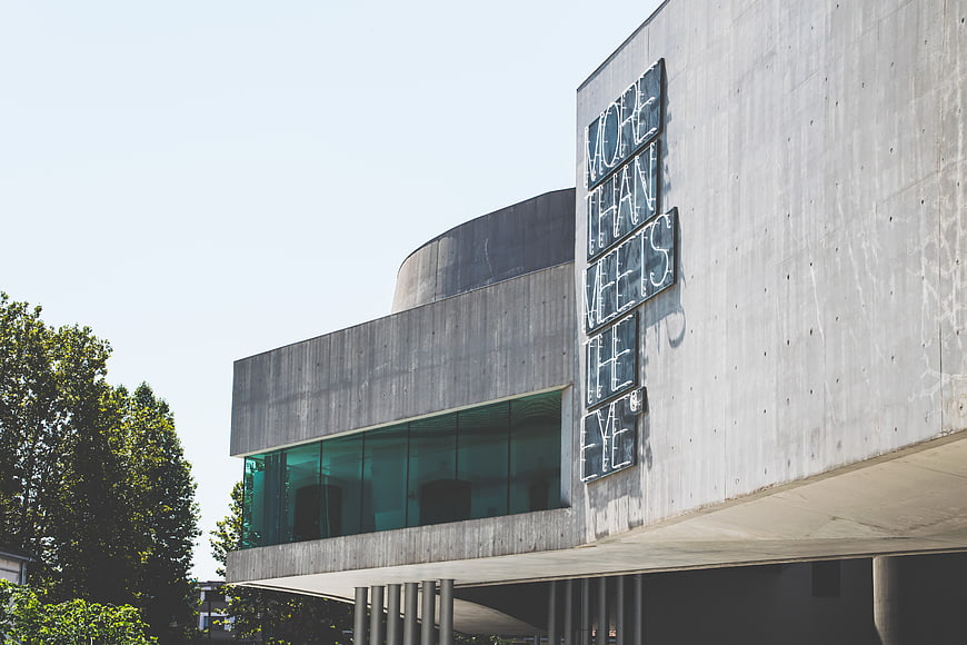 Modern Concrete Building with 'More Than Meets The Eye' Sign