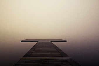 Minimalist Wooden Dock Disappearing into Thick Fog