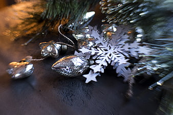 Silver Christmas Ornaments and Snowflake on Dark Wood