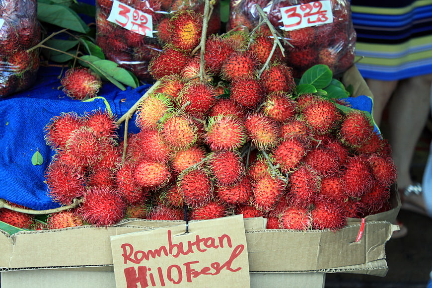 Fresh Red Rambutan Fruit at Outdoor Market
