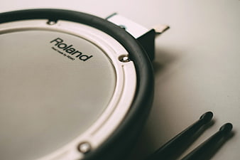 Close-up of Roland electronic drum pad with drumsticks