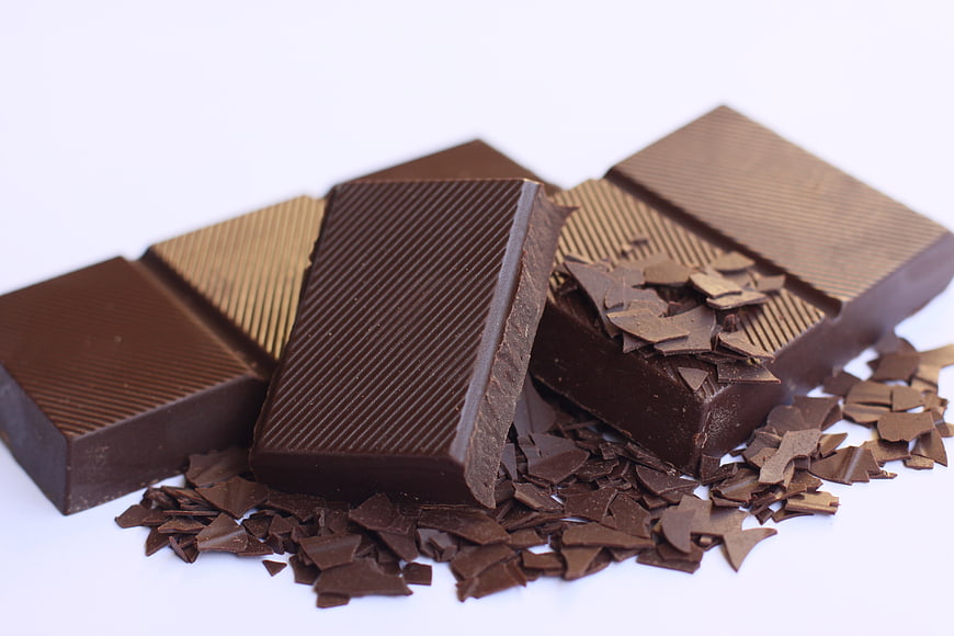 Assorted Chocolate Bars and Shavings on White Background