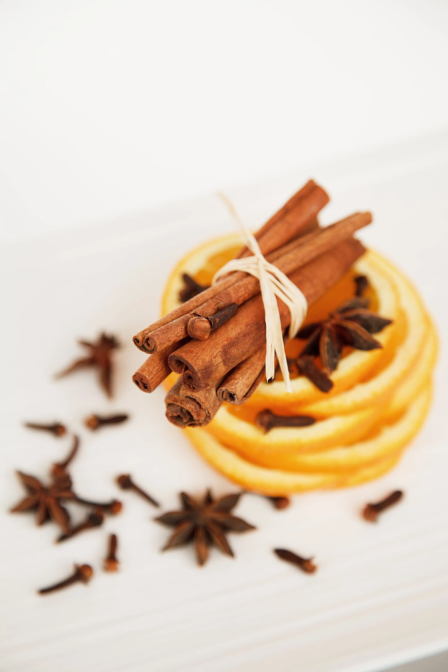 Cinnamon Sticks, Star Anise, and Orange Slices on White