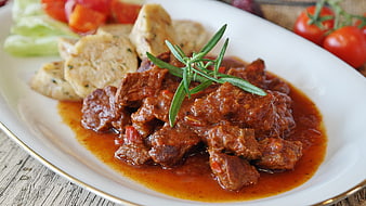 Hearty Beef Goulash with Bread Dumplings on White Plate
