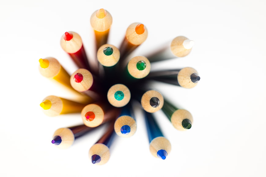 Top View of Colorful Pencils Arranged in a Circle on White