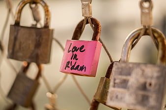 Pink Love Lock with Handwritten Message on Rusty Fence