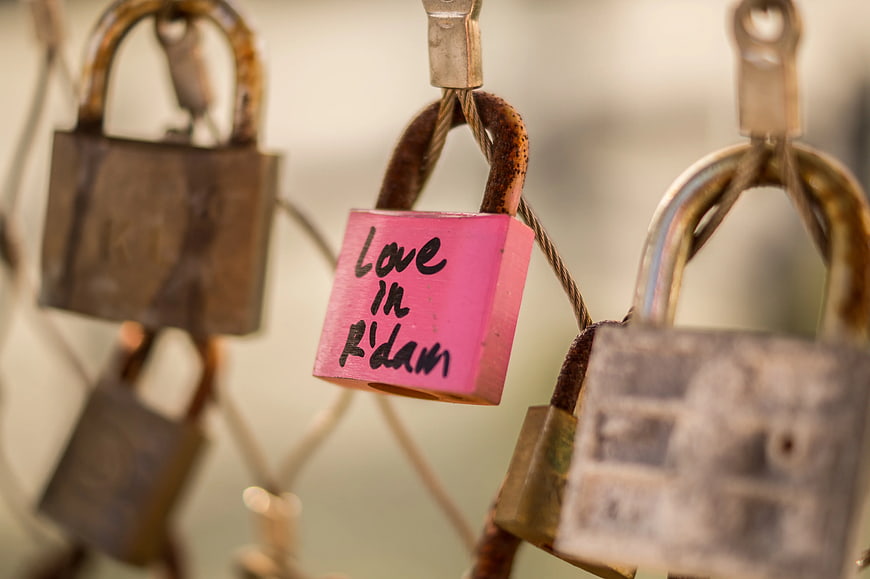 Pink Love Lock with Handwritten Message on Rusty Fence