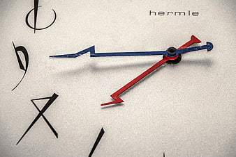 Close-up of Hermle clock face with red and blue hands