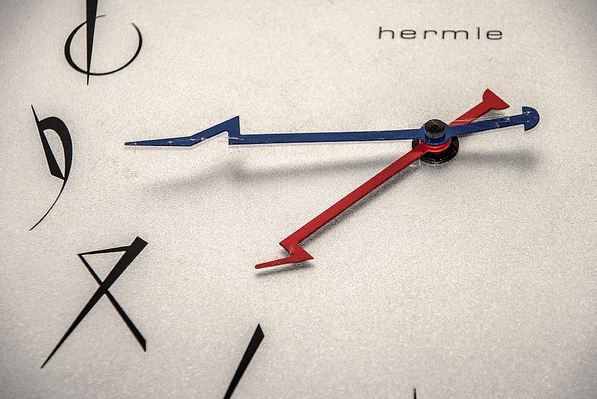 Close-up of Hermle clock face with red and blue hands