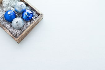 Blue and Silver Christmas Baubles in Wooden Tray on White Background