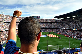 Soccer fan cheering at Camp Nou stadium