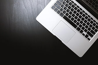 Silver Laptop Keyboard on Dark Wood Desk