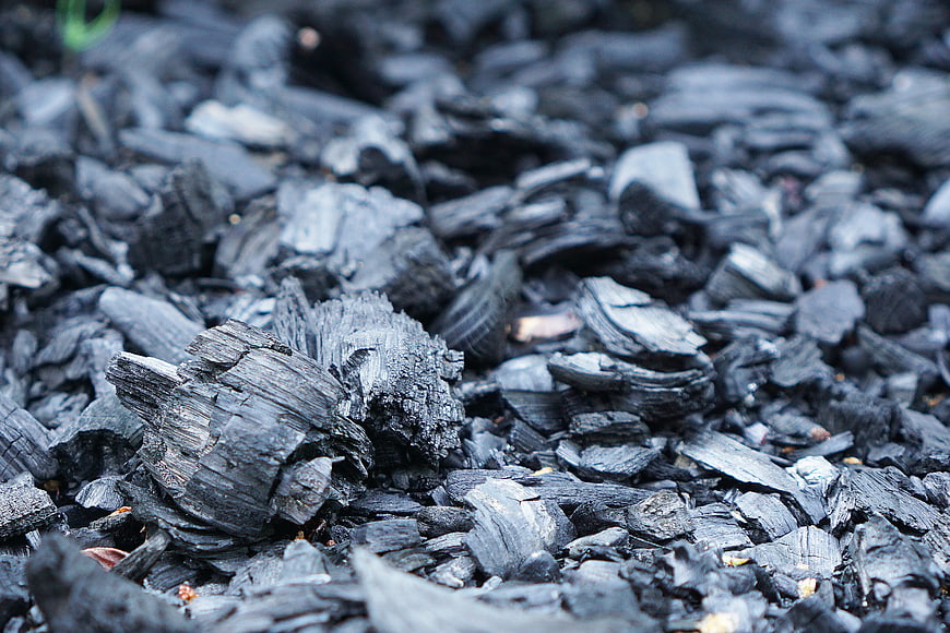 Close-up of Charcoal Pieces and Burnt Wood Texture