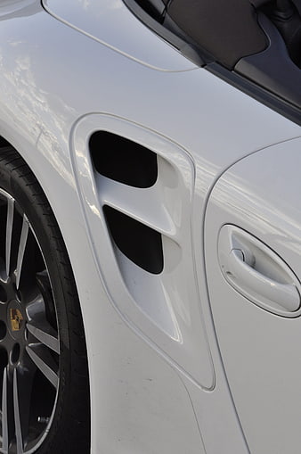 Close-up of white Porsche 911 Turbo side vent and wheel