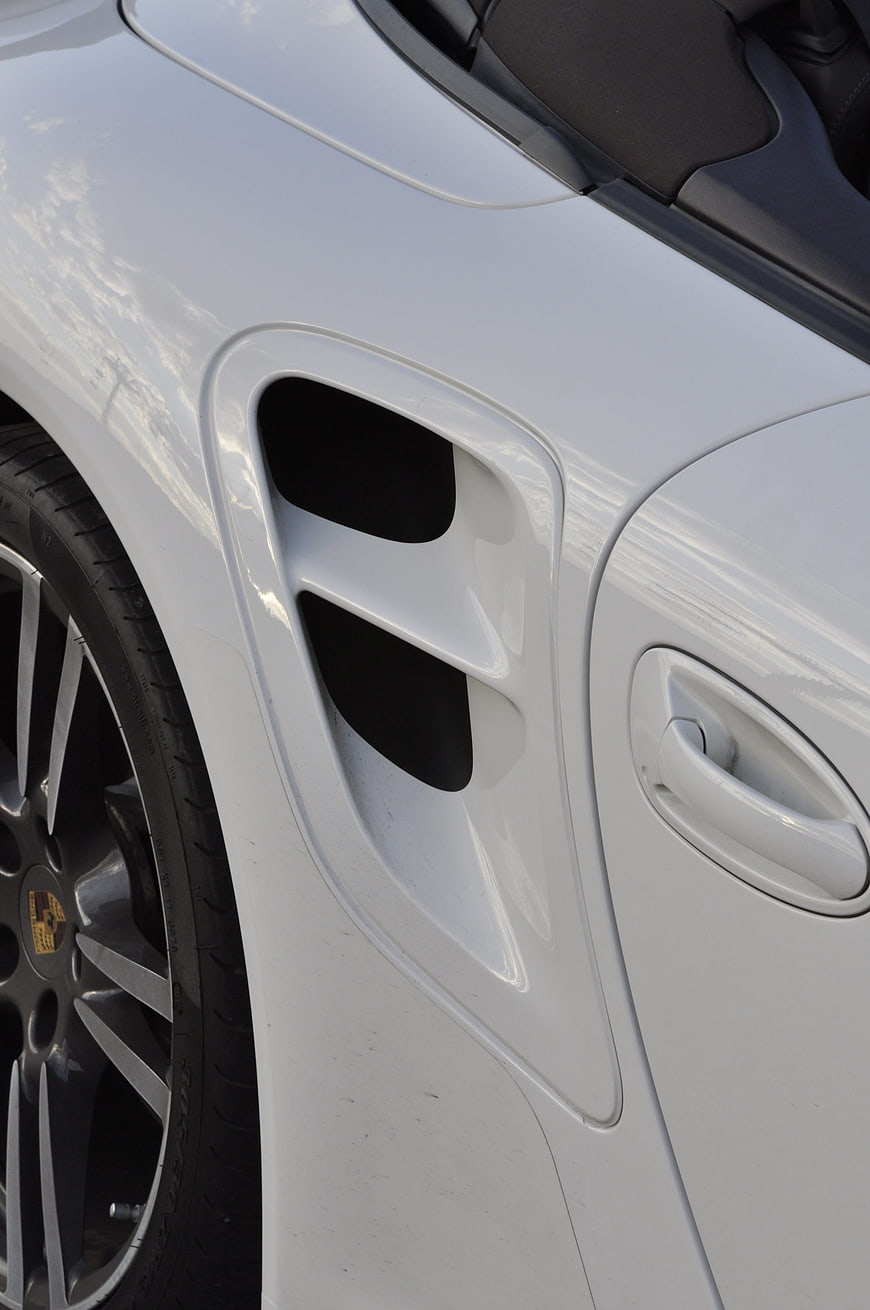 Close-up of white Porsche 911 Turbo side vent and wheel