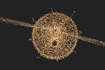 Giant spherical Christmas light ornament against night sky
