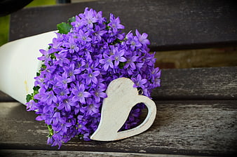 Purple Bellflower Bouquet With White Heart Ornament On Weathered Wood