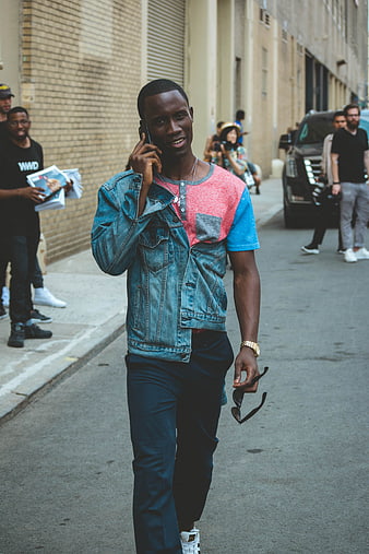 Stylish Black Man Walking and Talking on Smartphone in City Street