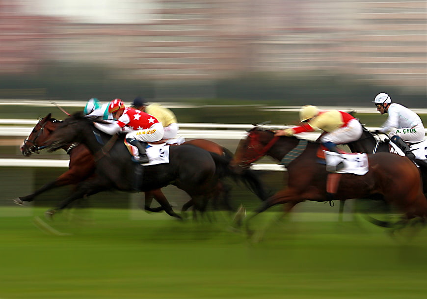 Horse Racing Competition With Jockeys On Track