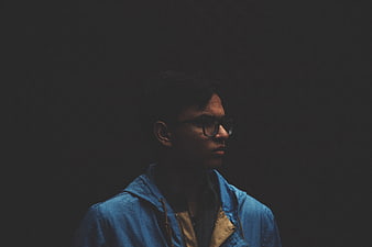 Moody Portrait of Man in Blue Jacket and Glasses