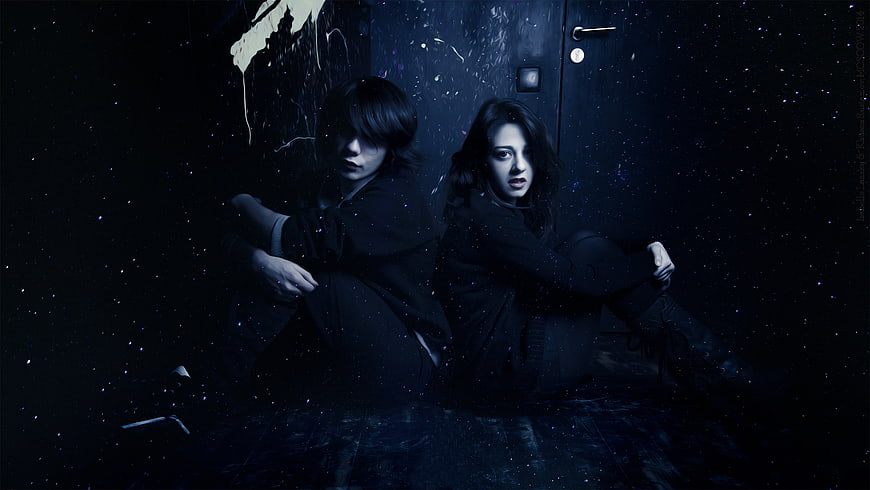 Gothic Couple Sitting Back to Back in Dark Starry Room
