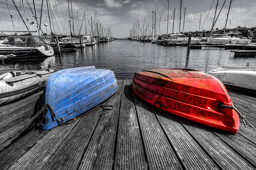 Colorful Blue and Red Kayaks on Wooden Dock in Marina
