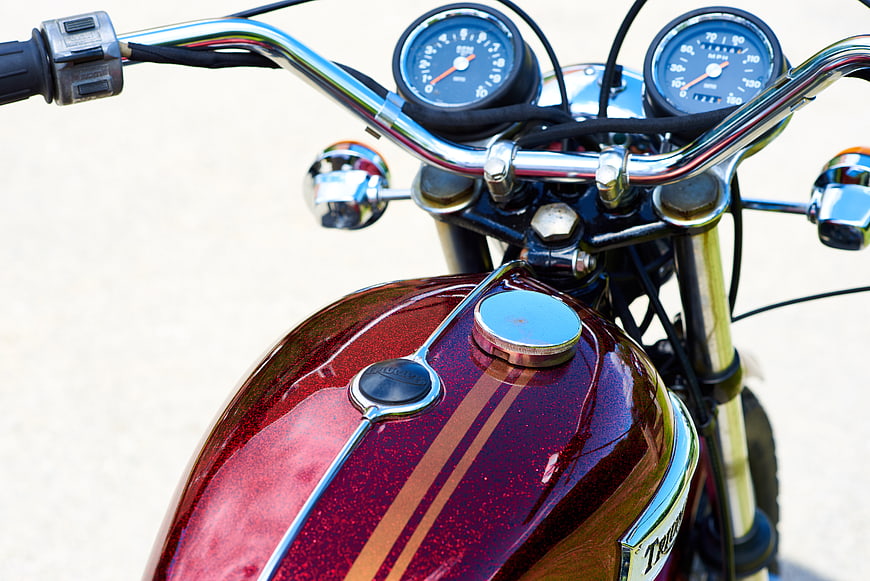 Close-up of Vintage Red Motorcycle Tank and Chrome Handlebars