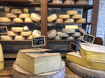 Assortment of French cheese wheels in a rustic shop
