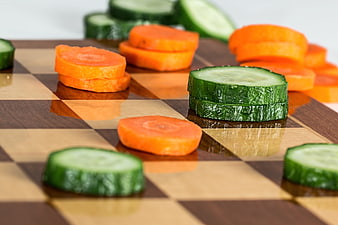 Sliced Carrots and Cucumbers on Wooden Chessboard