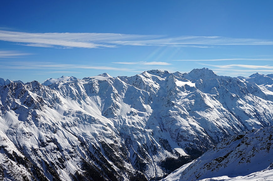 Snowy Mountain Peaks in the Alps Under Blue Sky