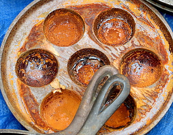 Top view of rusty vintage muffin pan with baking tool